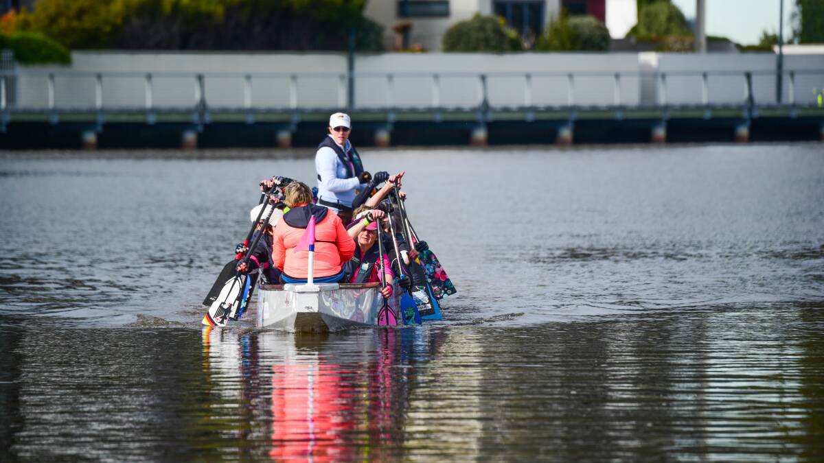 PRIZE PADDLERS: Dragons Abreast Northern Tasmania Inc paddlers train on the North Esk River at the beginning of October. Picture: Paul Scambler