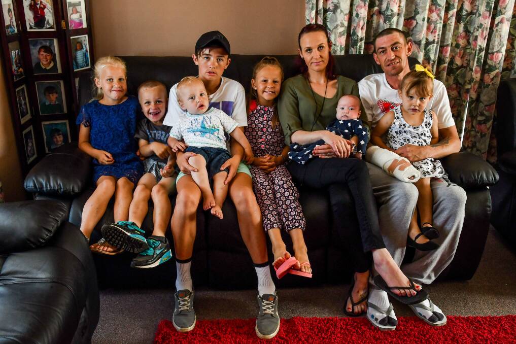 FIGHTING BACK: Parents Sarah Purcell and Adam Triffett with their children, Amali Rose, Jack, Seth Hutton, Tallis, Piper, Ollie and Timayia. 