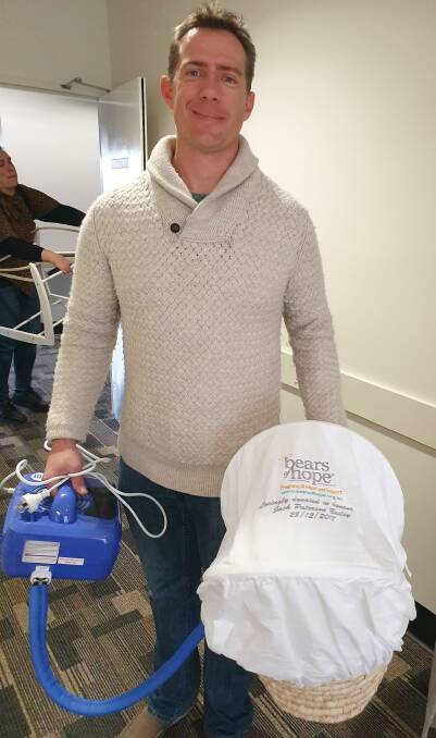 Adam leaving hospital with the Bears of Hope bassinet.