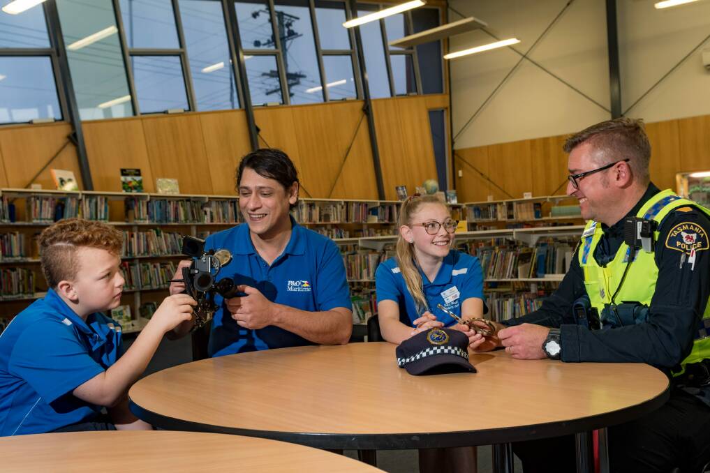 MENTORS: East Tamar Primary School grade 5 student Tate Lowery talks ship navigation with captain Freddie Anis, along with with student Aliyah Devlin and police officer Nathaniel Eldershaw. Picture: Phillip Biggs 