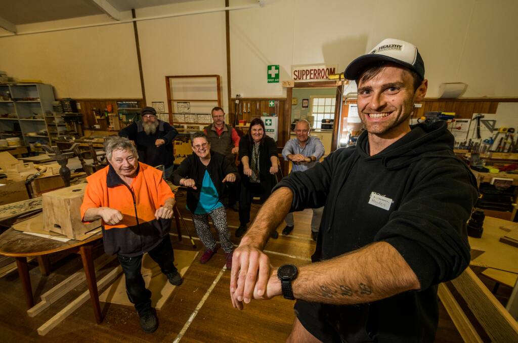 ACTION: Healthy Tasmania project co-ordinator Hayden Fox leads Ravenswood Healthy Shed participants in some exercise, as part of the 14 week program. Picture: Phillip Biggs 