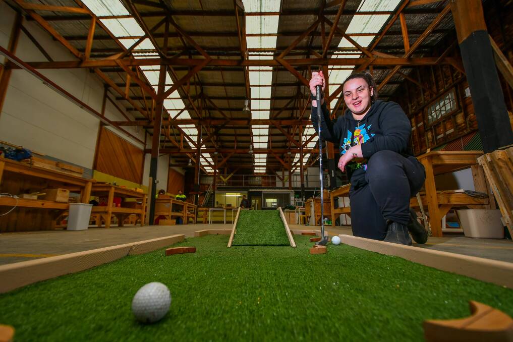 SKILLS: Codilee Spence tests out the mini golf course being made through Envision Employment Services work for the dole program, at the organisation's new workshop at Invermay. Pictures: Scott Gelston
