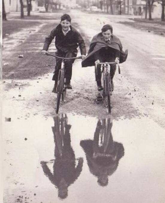 YOUTH: Friends Peter Moles and Dennis Quillerat, aged 11, pictured in 1968 riding their bikes through floodwaters on Holbrook Street at Invermay. Picture: Eddie Kerfoot