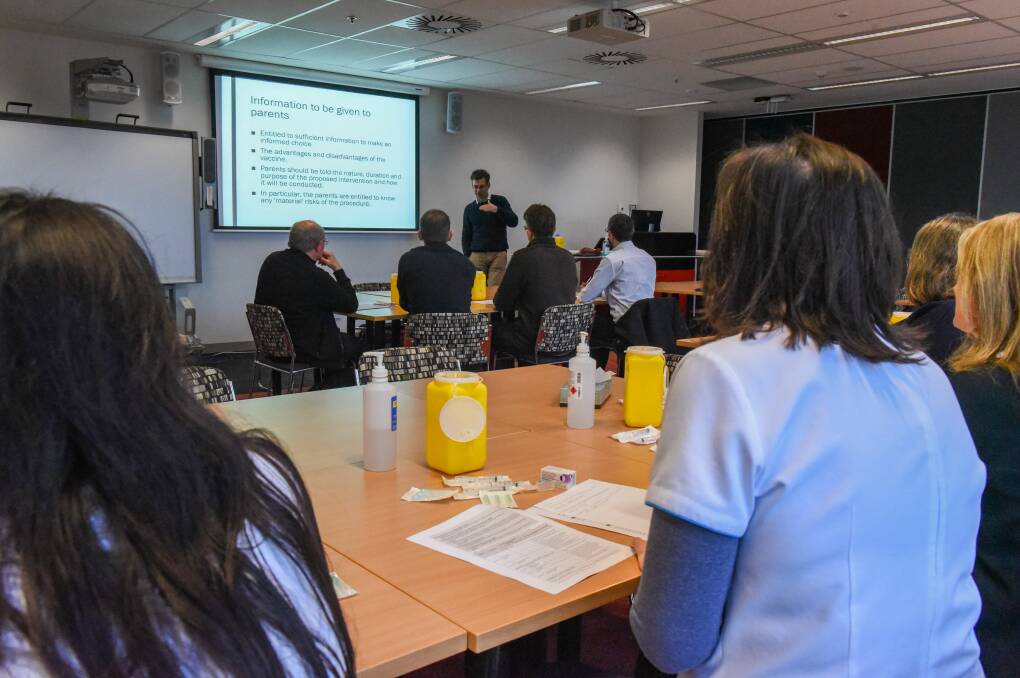 Chief pharmacist Peter Boyles talks with Launceston pharmacists about the meningococcal vaccine at Launceston Clinical School on Wednesday. Picture: Paul Scambler