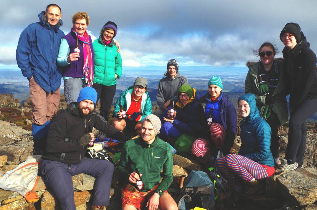 PROUD: Zane Robnik, pictured front and centre, celebrating reaching the summit of Stacks Bluff his final Tasmanian Abel, with friends and family. Pictures: Supplied. 