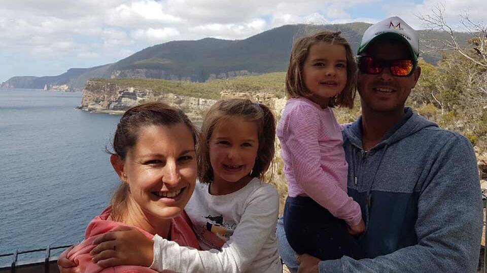 Greg Longmore, 36, remains in an induced coma. Pictured with wife Erin and their two children. Picture: Supplied 