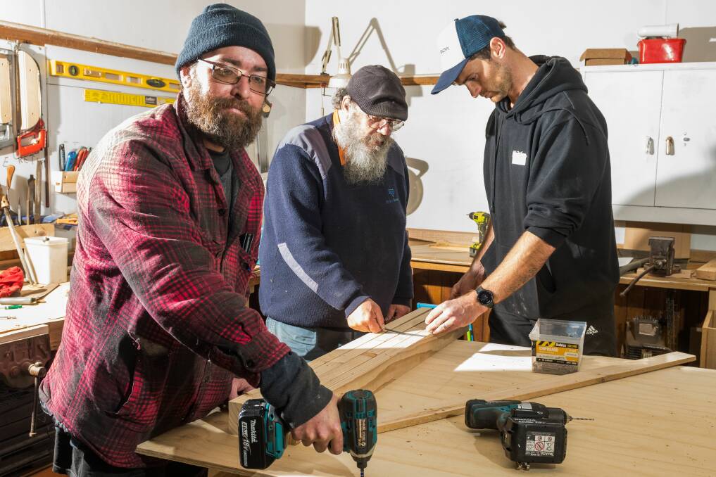 Anthony Whiting, Casper Staak and Healthy Tasmania project coordinator Hayden Fox, at Ravenswood mens shed. 