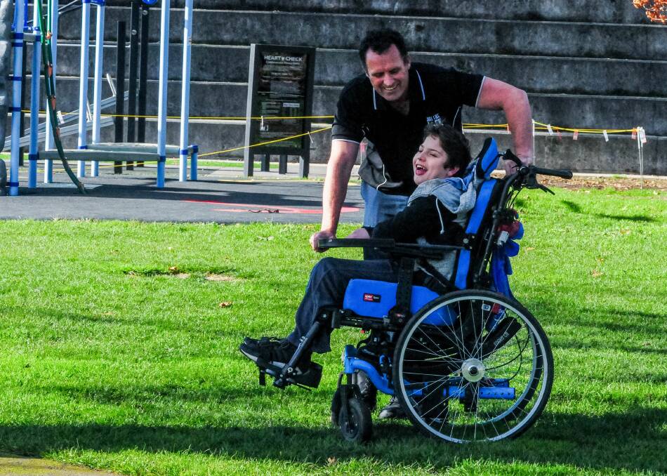 PLAY TIME: Chris Duffy with son Jack, who will soon be able to play on an all-inclusive wheelchair carousel planned for Royal Park. Picture: Neil Richardson 