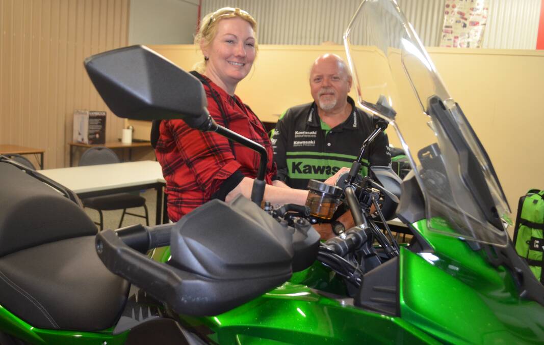 COLLABORATION: TasTAFE student Jessica Mustart with Kawasaki assistant manager technical services Jeremy Fuller and the donated bike. Picture: Jessica Willard	