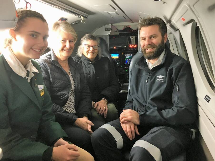 EXCITED: Neika Morrow, Christine Wadley and Gail Wade are shown the RFDS Tasmania Beechcraft King Air plane by pilot captain Oliver Doig. Picture: Supplied