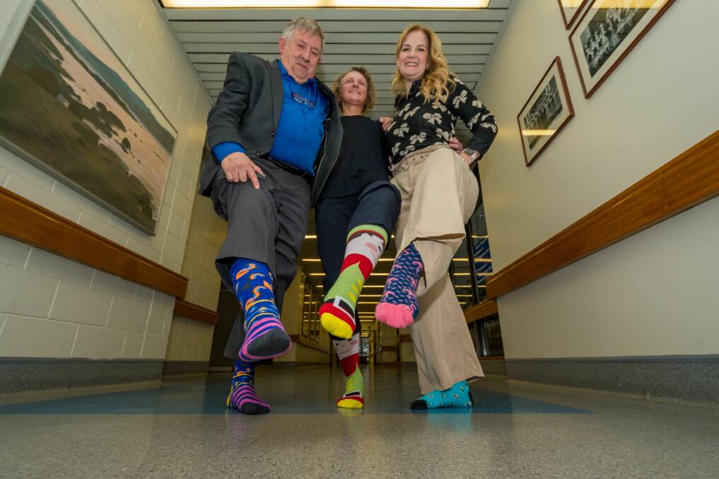 MESSAGE: Dr Peter Renshaw, Leanne Evans and GP liaison consultant Izzy Morse ahead of CrazySocks4Docs day. Picture: Phillip Biggs 