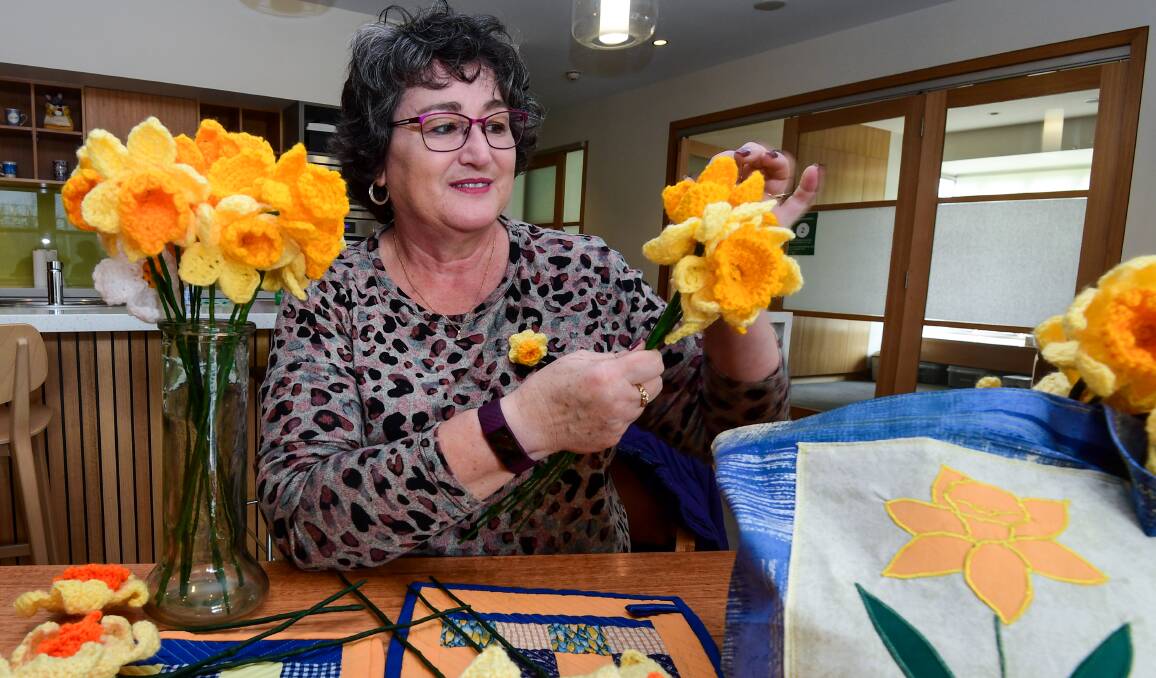 CHALLENGE: Breast cancer survivor Karen McDermott has crocheted 40 daffodils to help fundraise for Cancer Council Tasmania. Picture: Neil Richardson