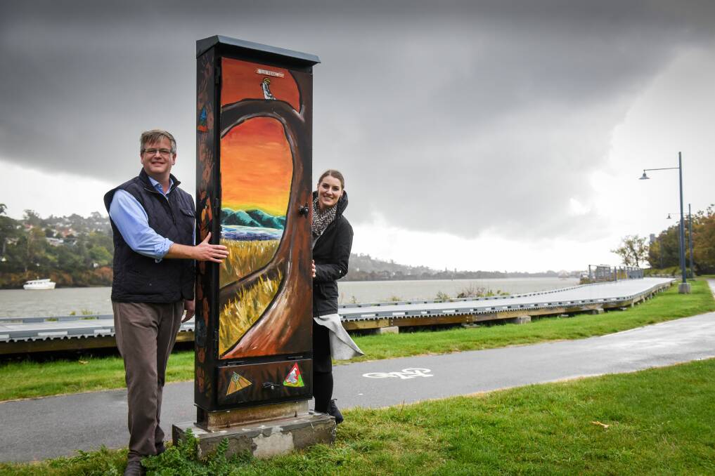PROJECT: Launceston's Youth Advisory Committee co-chair Simon Wood and Youth Development officer Claudia Garwood, with one of the painted electrical boxes along Royal Park's boardwalk. Picture: Paul Scambler