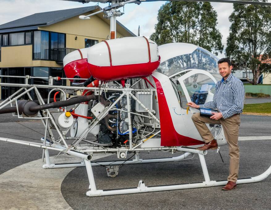 PASSION: Ansett Aviation Launceston site manager Michael Douglas, with one of the helicopters that will be used for pilot training and scenic flights. Pictures: Neil Richardson