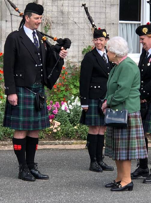 HONOUR: John Ralph, of Launceston's St Andrews Caledonian Pipe Band, meeting Queen Elizabeth II at Balmoral Castle in Scotland. Pictures: John Seguin