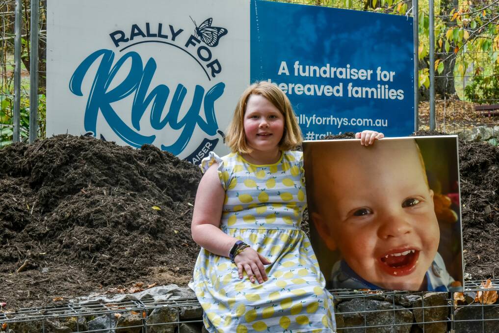 SUPPORT: Amalie Hodgett, 8, with a photo of brother Rhys, 2, at the site where a new Halo Seat will be installed at Punchbowl Reserve, in support of grieving siblings. Picture: Neil Richardson 