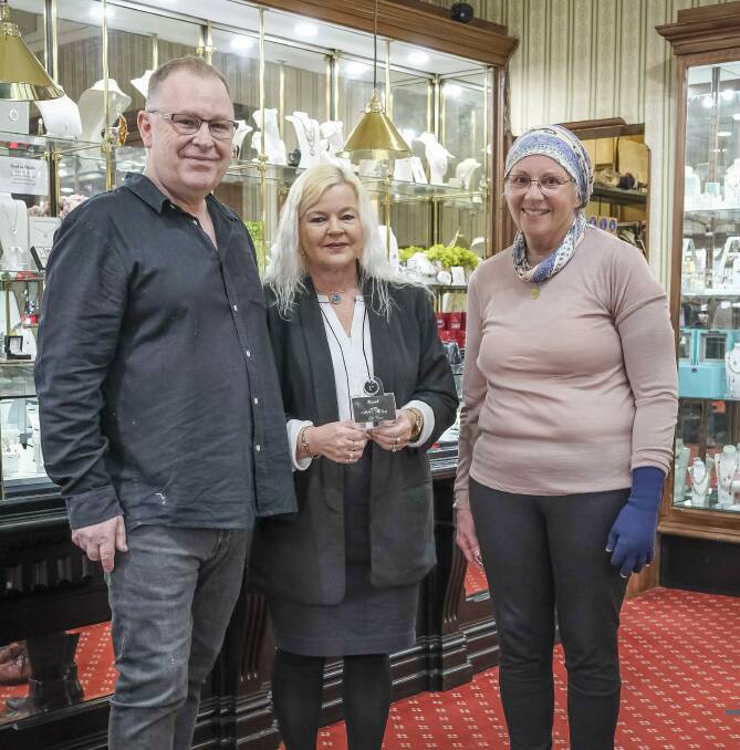 Tim and Karen Haab hold the pink diamond they have donated for the Sparkle for Hope Gala Ball, with Julie French. Picture: Craig George 