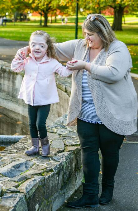 Isla with mother Kylie Wells, who said she cried for days when her daughter started walking. 