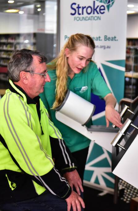 Paul Spence takes a stroke test assisted by Kianie Langer from Stroke Safe. Picture: Neil Richardson 