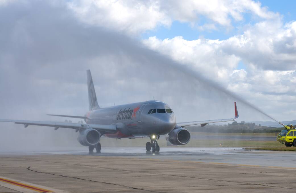 The first flight bound for Victoria sent off with a water cannon salute. Picture: Phillip Biggs 