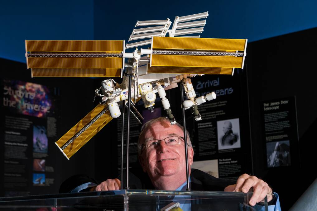 SPACE SPOTTER: Astronomer Martin George with an ISS replica on display at the Launceston Planetarium, which forms part of the Queen Victoria Museum and Art Gallery. Picture: Phillip Biggs