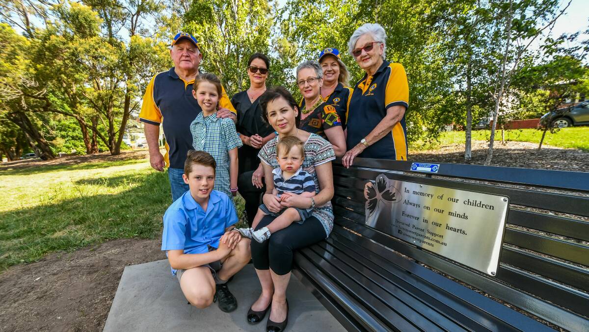 Bittersweet members Oliver, Delilah, Sarah and Franklin Barrett (front) with Lisa Bird, Karen Graham and Lions Club members John Dakin, Sue Moir and Margaret Whitmore at the new chair at Newstead Reserve. Picture: Phillip BIggs