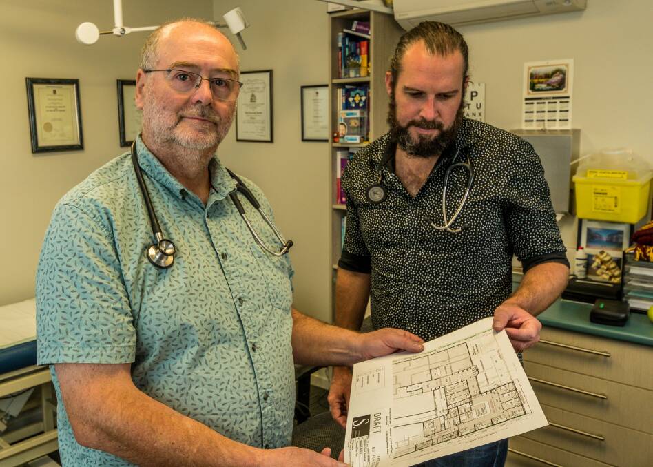 ACTION: Newstead Medical Centre's Dr Andrew Fair and Dr Toby Gardner, with plans for the proposed urgent care centre, which is open for comment until August 21. 