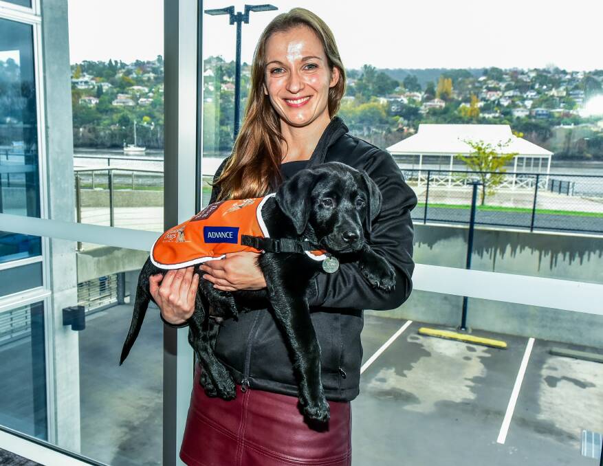 Guide Dogs Tasmania community fundraising coordinator Kristy Wright, with 11-week-old guide dog in training Victor. 