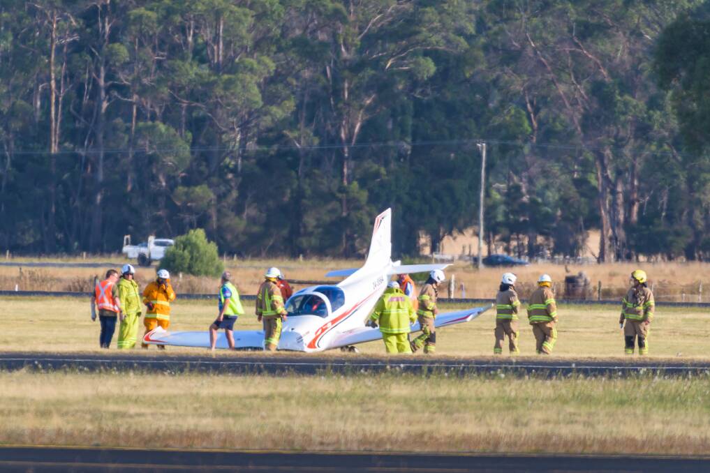 Emergency and airport personnel survey the damage. Picture: Simon Sturzaker