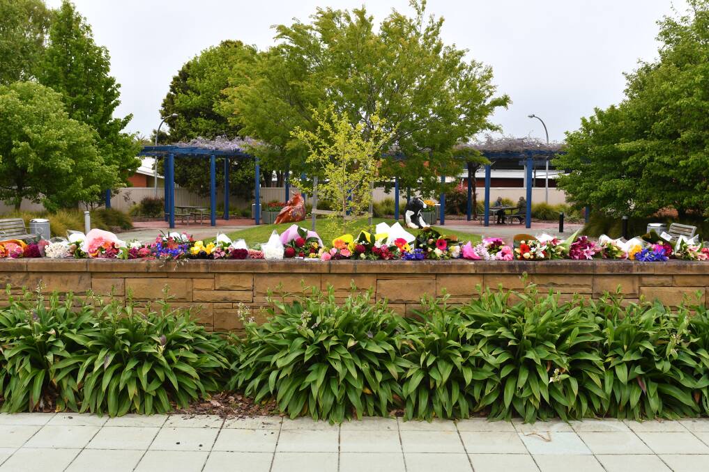 COMMUNITY: A floral tribute has been taking shape at Wynyard, where Coasters have left piles of bouquets in honour of the trio. Picture: Brodie Weeding