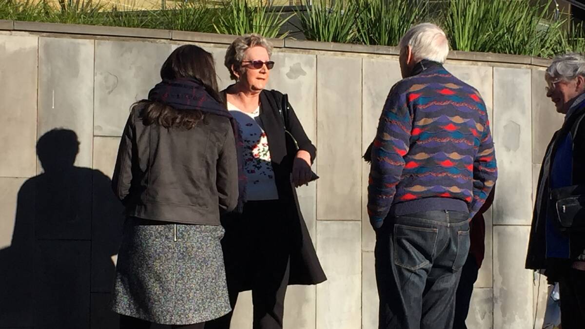 Barbara Etter (centre) speaks with supporters outside court on Monday.