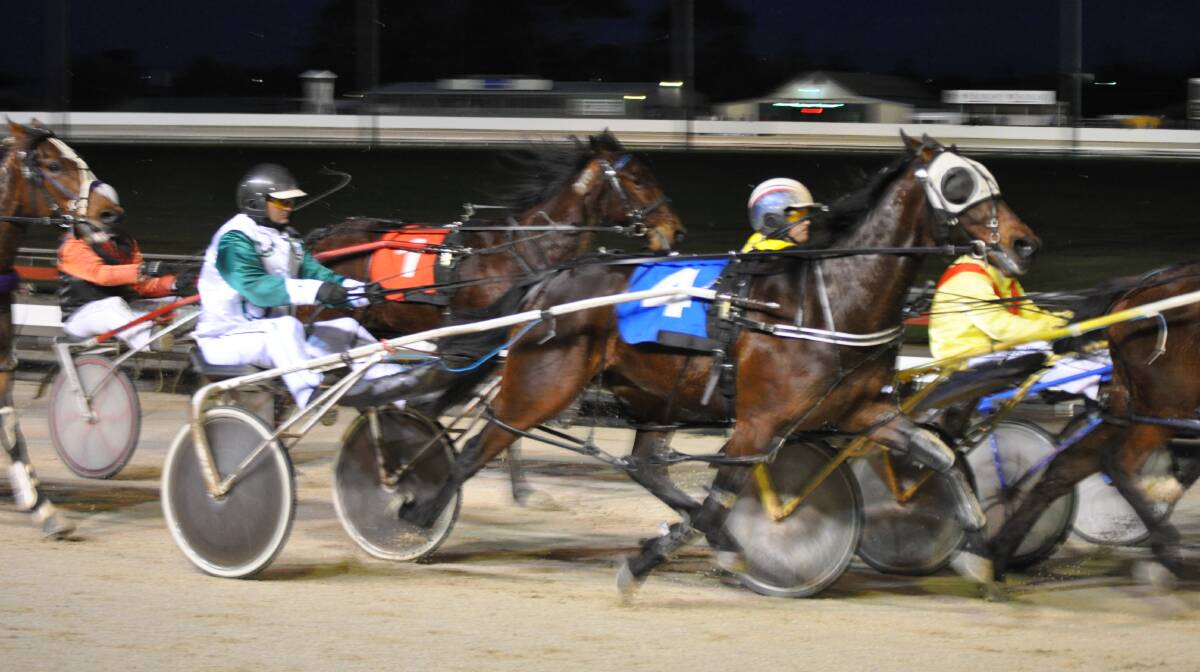 WAR DANCE: Driver Rohan Hadley makes a three-wide move at the bell on War Dan Star on his way to a win in Devonport on Friday night. Picture: Greg Mansfield