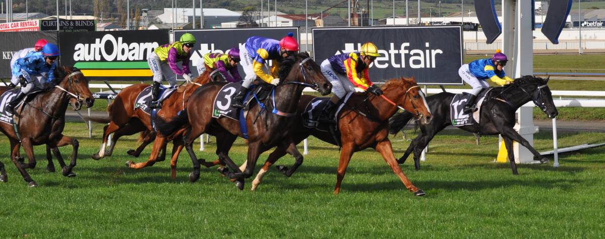 FIVE IN ROW: Top jockey Brendon McCoull wins his fifth consecutive Tasmanian Sires Produce on Hard Empire (centre) at Mowbray last year. Picture: Greg Mansfield
