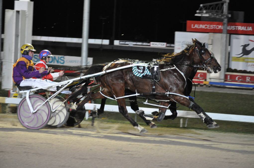 DUEL: Favourites Fortino (inside) and Gotta Go Henry go head-to-head at the bell in the third race at Mowbray on Wednesday night. Fortino went on to win and give driver Todd Rattray one of four wins for the night.
