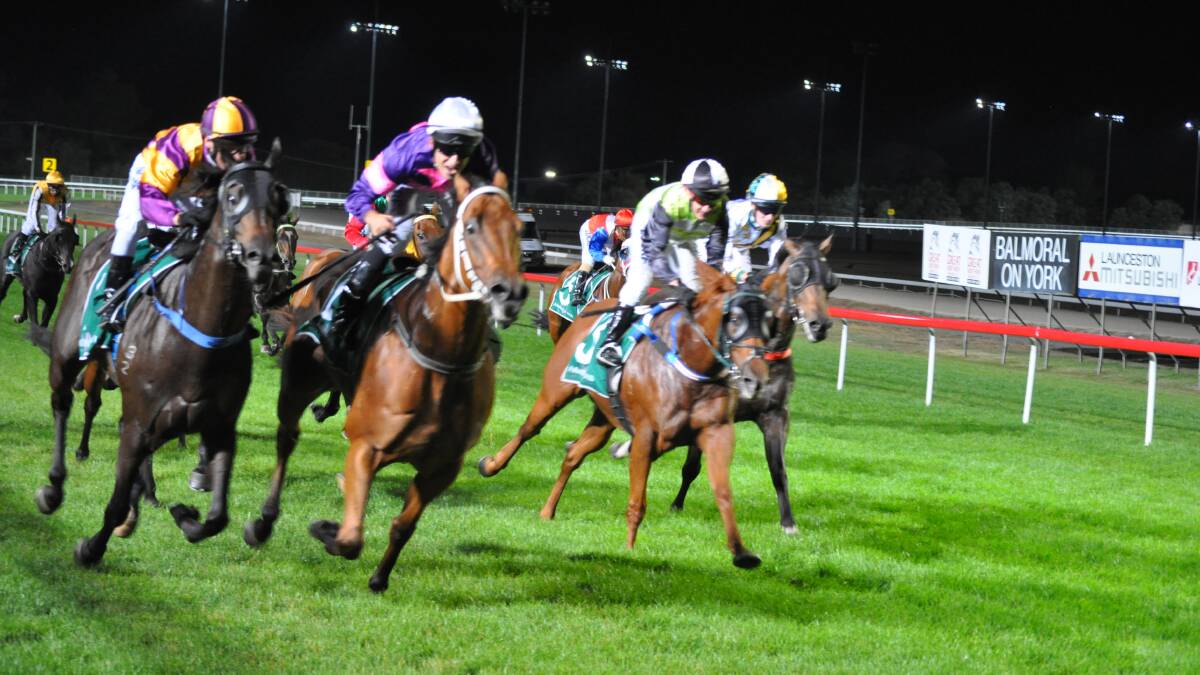 WIDE RUN: Radioactive, ridden by Ismail Toker, wins the Ismail Toker Handicap at Mowbray on Wednesday night. Pictures: Greg Mansfield