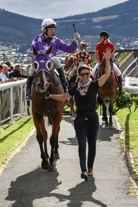 FINED: Craig Newitt was jubilant as he returned to scale on Hobart Cup winner Eastender, led by strapper Tania Coward, but was later fined $1000 for excessive whip use. 