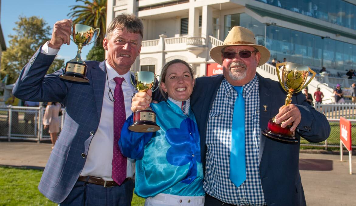 Trainer John Blacker, jockey Siggy Carr and Rob Hammond representing the owners with their trophies.