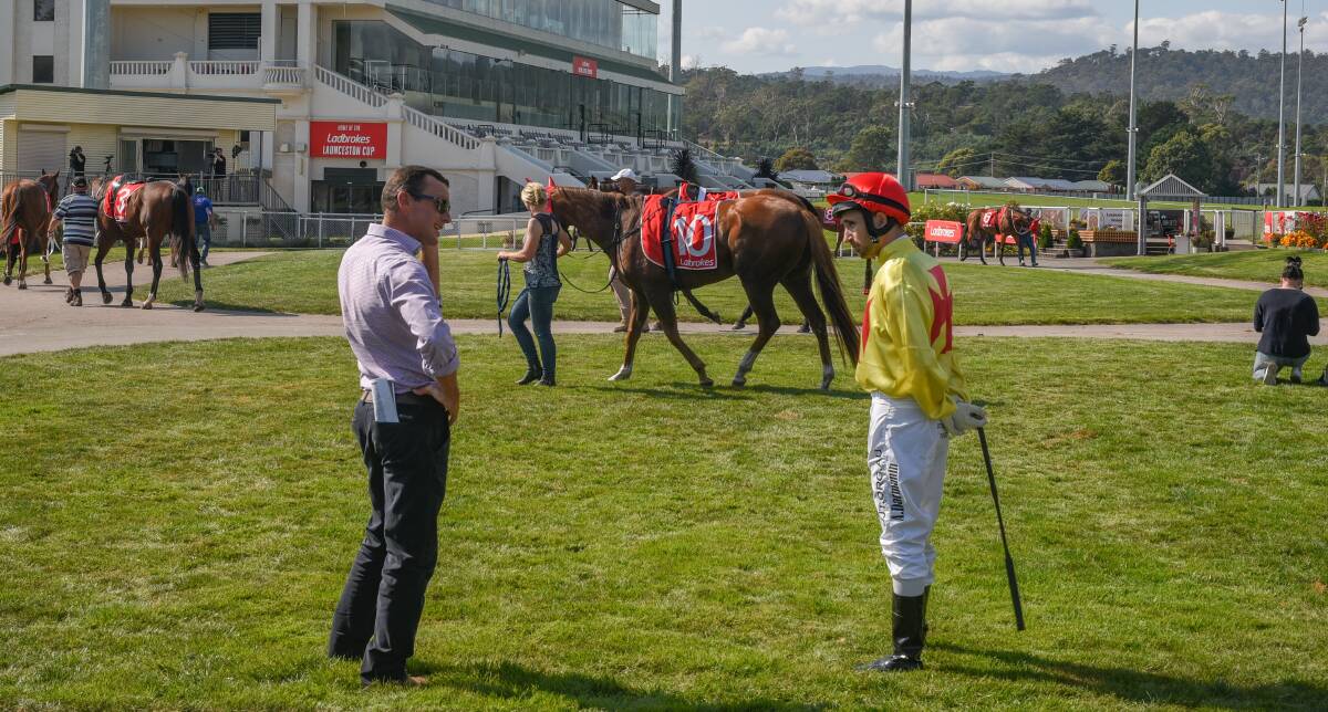 KEEPING DISTANCE: Trainer Adam Trinder and jockey Anthony Darmanin practise social distancing as they discuss tactics before a race at Mowbray on Saturday. Picture: Paul Scambler