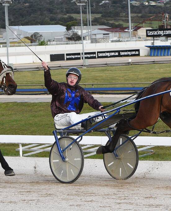 FIRST WIN: Driver Ben Woodsford gives a victory salute as he scores on Rocket Blaster at Mowbray on Sunday night. It was the first harness winner for gallops trainer Stephen Lockhart. Picture: Stacey Lear