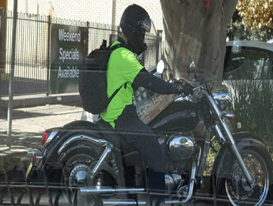 NABBED: A motorcyclist fined for carrying an unsecured load on King Street. Picture: NSW Highway Patrol