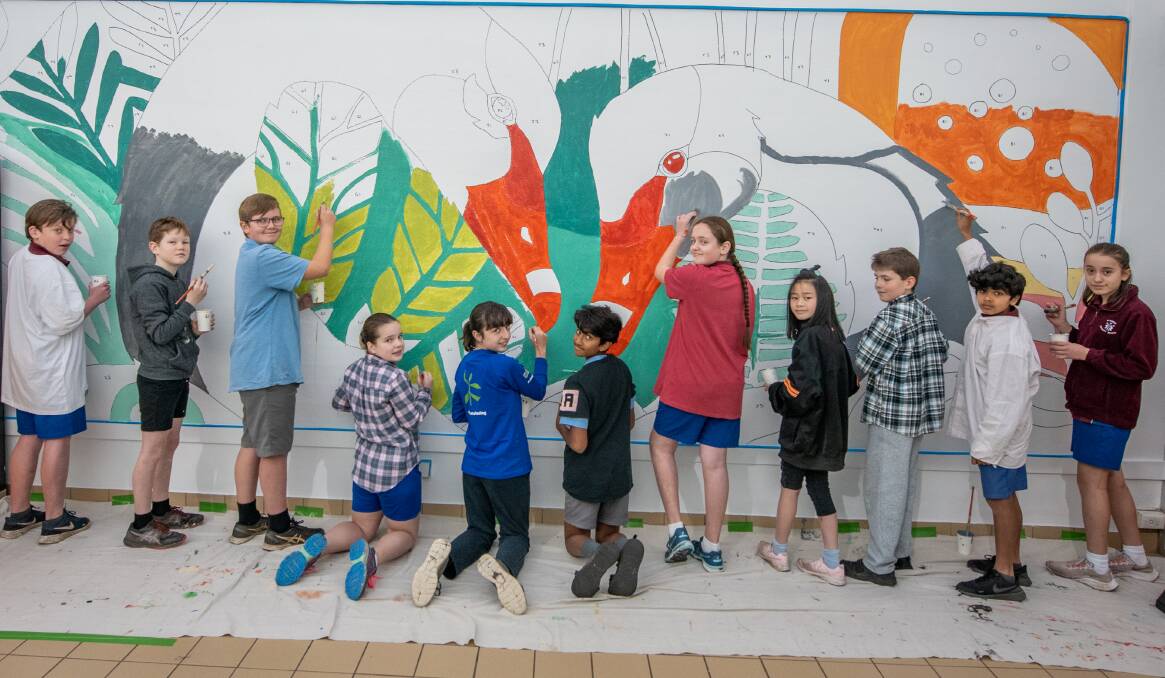 Riverside Primary students Henry Rathbone, Mason Squires, Tyson Saunders, Olivia Quarry, Jenny Titley, Cross Dean, Eliza Dawe, Dasi Pan, Kian Honeychurch-Garcia, Adam Shams and Lily Taylor help paint the mural at Riverside Plaza. Picture: Paul Scambler