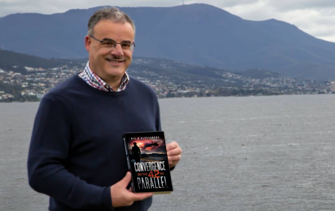 Tasmanian author Nic D'Alessandro with his novel Convergence on the 42nd Parallel. Picture: Supplied 