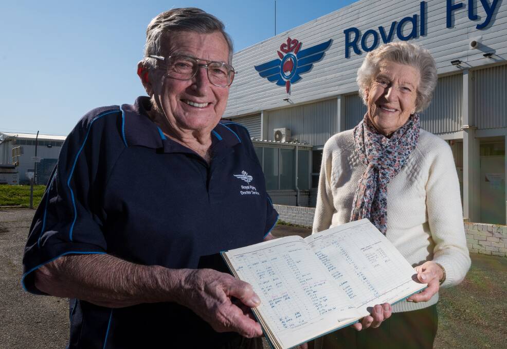 Margaret Beattie, wife of the late Neil Beattie, and Lindsay Millar, former RFDS Tas chair and former pilot with log book. Picture: Phillip Biggs. 