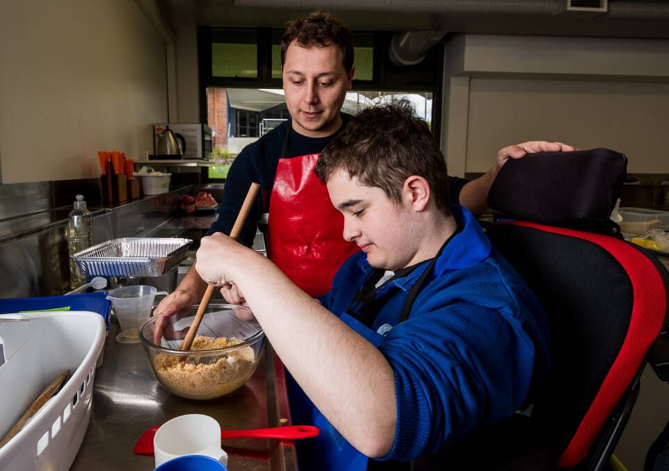 INCLUSIVE: Grade 9 Kings Meadows High School student Ethan Stebbings using the workspace designed for him with teacher's aide Grady Lynch. Picture: Phillip Biggs 