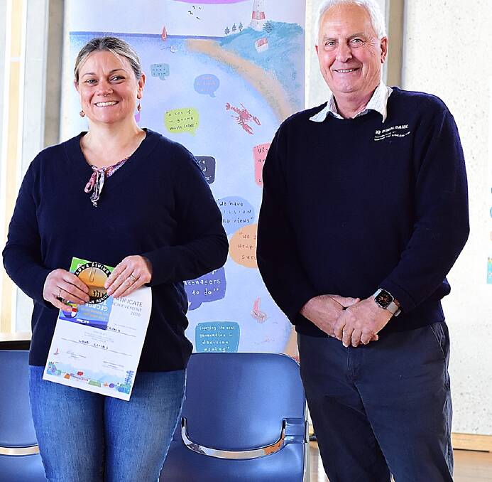 Sarah Hickling, who collected a prize on behalf of Paul Hickling, and James Cameron, president of the George Town Chamber of Commerce. Picture supplied. 