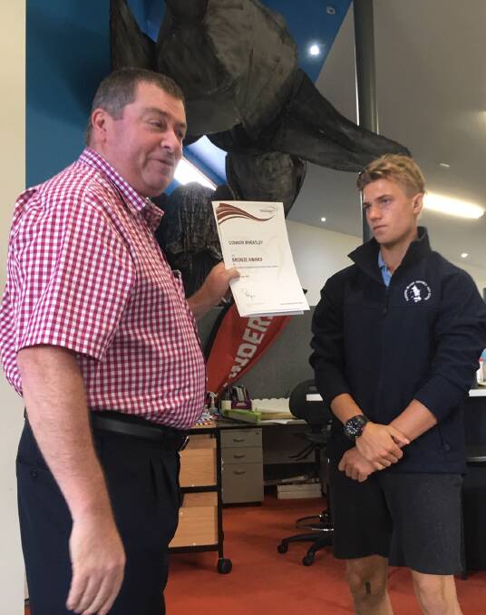 Flinders Island District High School student Connor Wheatley accepting the Duke of Edinburghs International Award from state manager of the award Steve Halloran. Picture: Supplied

