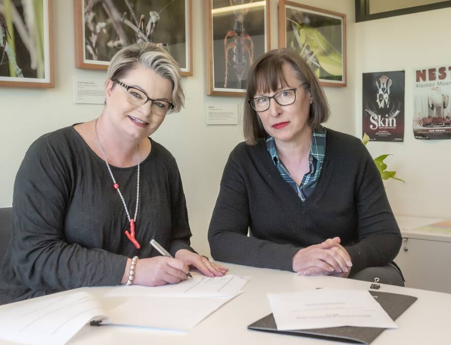 QVMAG general manager of arts and cultural services Tracy Puklowski and TMAG director Janet Carding sign MoU. Picture: Craig George