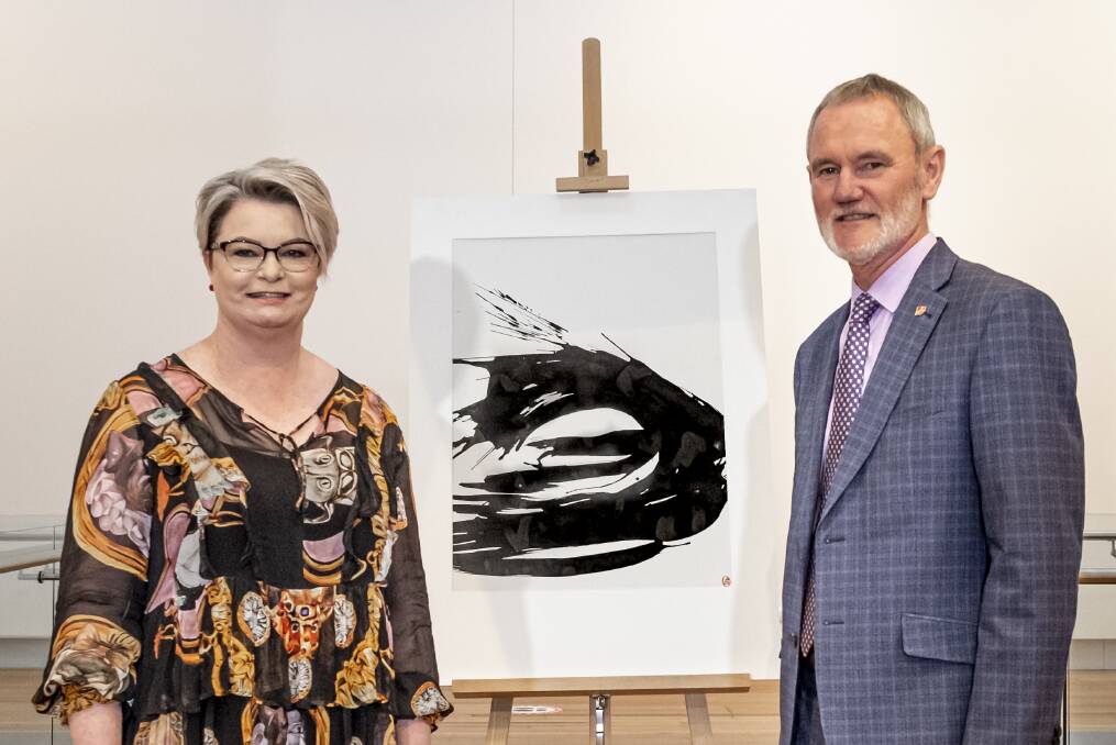QVMAG General manager of creative arts and cultural services Tracy Puklowski and Launceston mayor Albert van Zetten with Brett Whiteley's Waves V. Pictures: Craig George