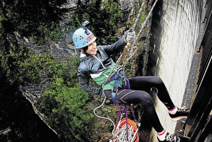 The Sunday Examiner reporter Manika Dadson abseiling down the Gordon Dam.
Picture: Phillip Biggs. 