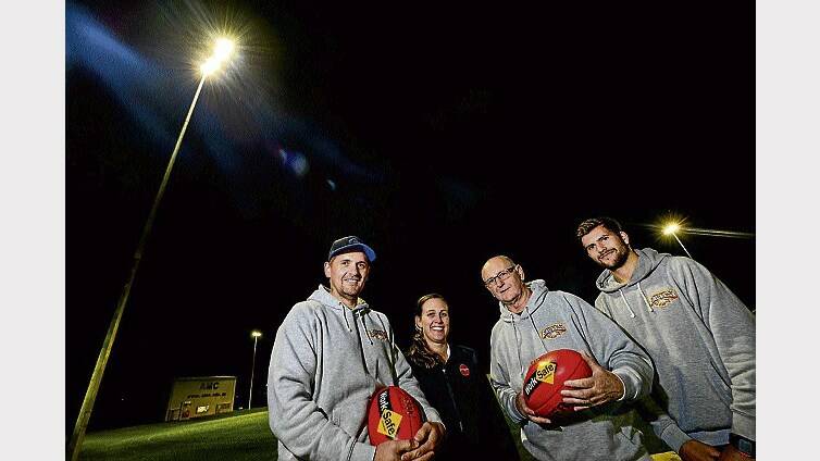Uni-Mowbray Football Club's senior coach Nathan Lowe, gym business operations manager Sarah Campbell, president Wayne Thompson and vice-captain Tom Hartley get a feel for the new lights. Picture: PHILLIP BIGGS